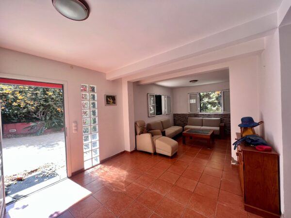 Living room with wide open doors of Funchal City Villa for sale, Madeira Island.