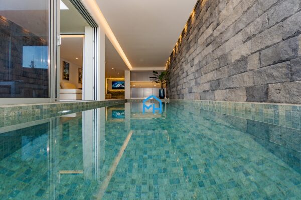 Indoor swimming pool with natural blue emerald tiles